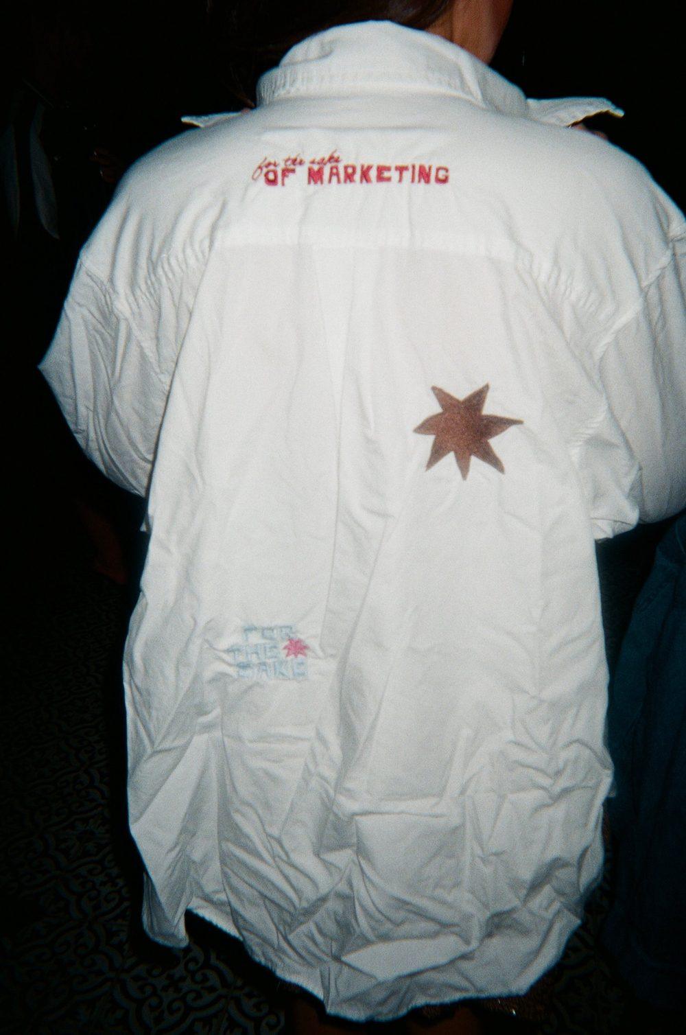 An embroidered For the Sake of Marketing shirt